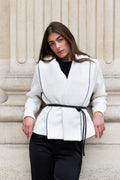 Boucle jacket by steph alise with an oversized lapel and faux leather tie belt